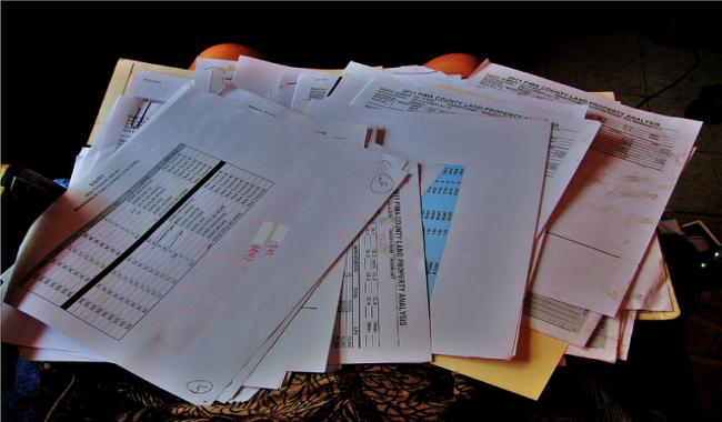 Documents piled on a table